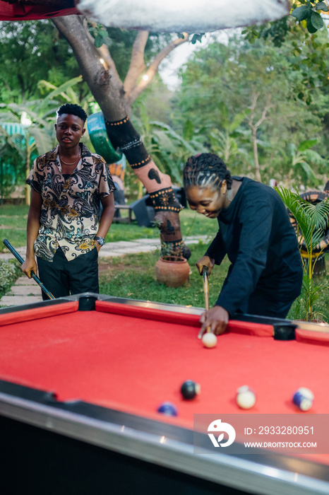 Queer masculine women playing pool