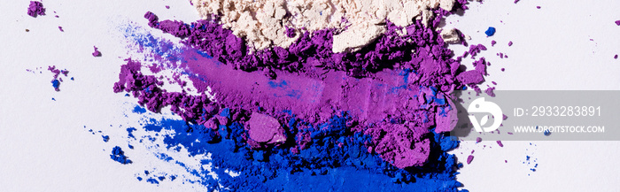 top view of purple, blue and white eyeshadow powder, panoramic shot