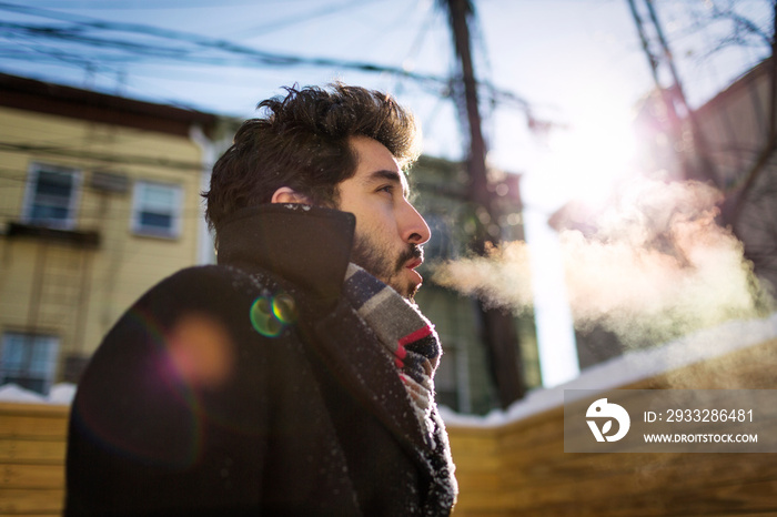 Man breathing out during winter