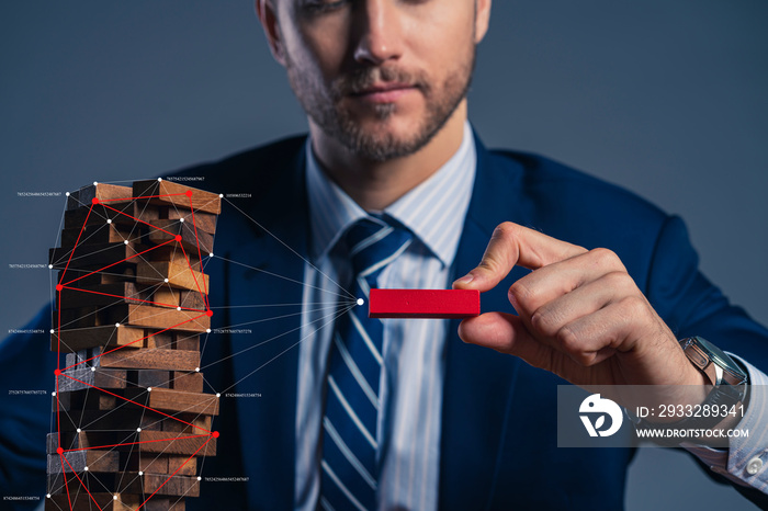 business man try to build wood block on wooden table and black background business organization star