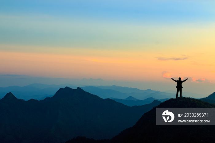 silhouette of businessman on mountain top over sunset sky background, business, success, leadership 