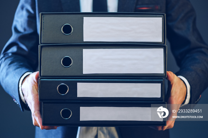 Businessman with corporate files in four document binder