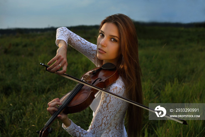 Girl with violin in the forest