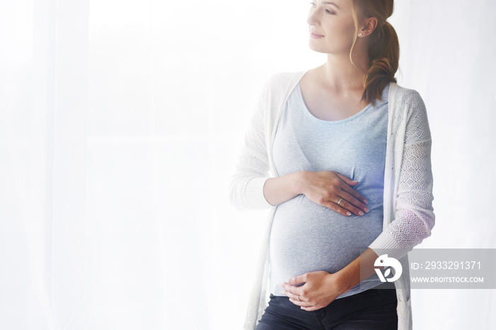 Portrait of cheerful pregnant woman at studio shot