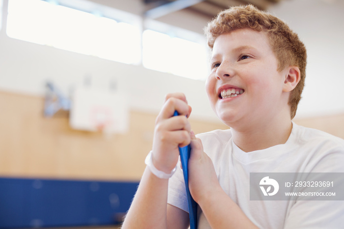 Elementary male student with floor hockey stick