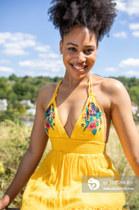 Portrait of young woman wearing yellow dress