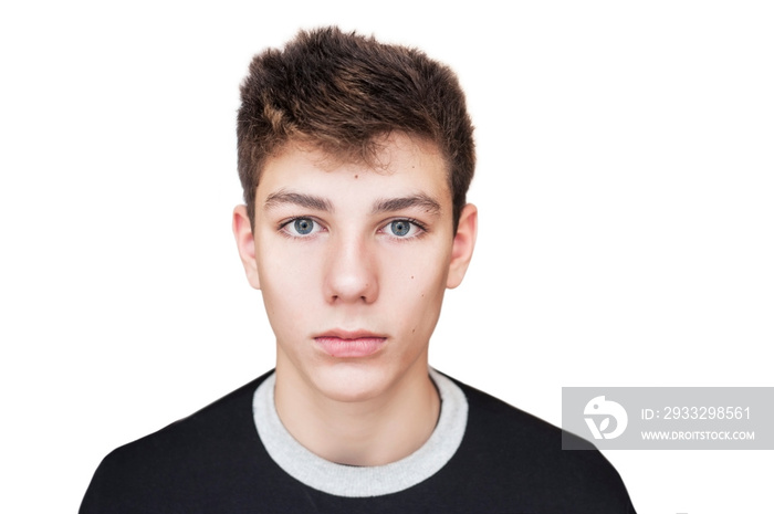 A serious teenager with a beautiful face, a charismatic look on a white background. Isolated