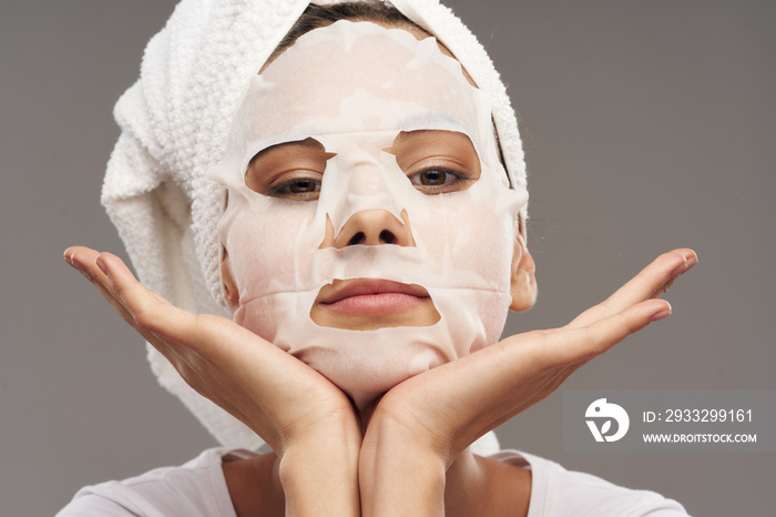 woman in a mask with a towel on her head skin care cosmetology