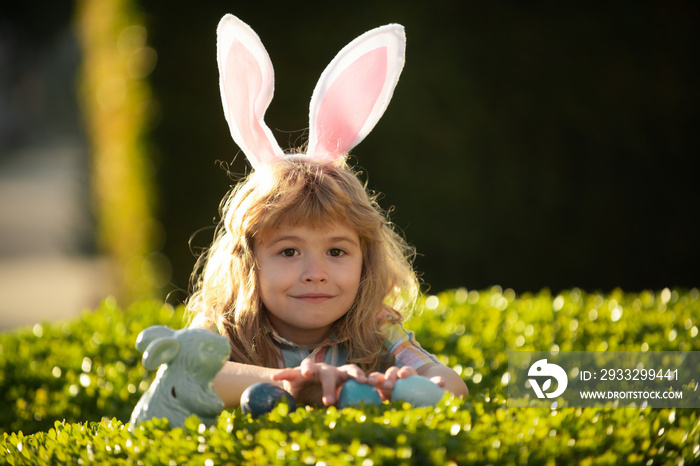 Child boy with easter eggs outdoor. Easter egg hunt. Fynny kids face. Happy easter day. Child with b