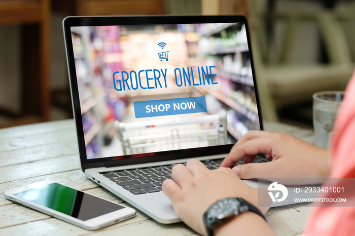 Hands typing laptop computer with grocery shopping online on screen background, business and technol