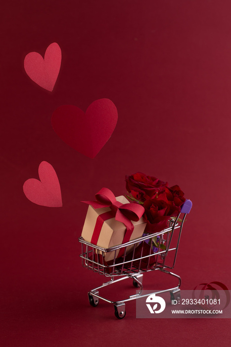 St. Valentines Festive sale concept with gift box rose, and red paper hearts in the shopping cart a