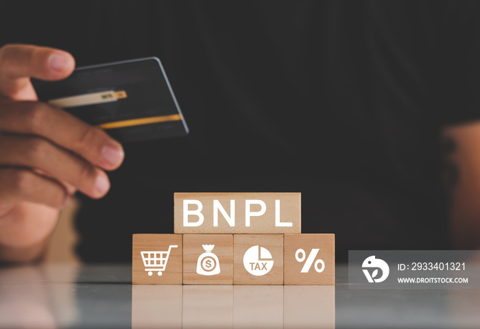 Mans hands holding credit card with BNPL icons. Buy now pay later online shopping concept. Online s