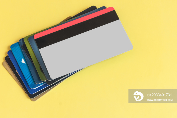 Stack fo colorful credit cards on pastel color background. Banking concept. Copy space.