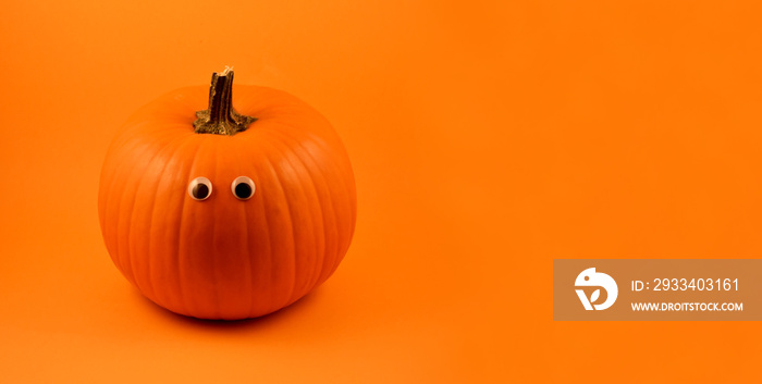 Cute Halloween pumpkin with googly eyes stock images. Halloween pumpkin with googly eyes on a orange