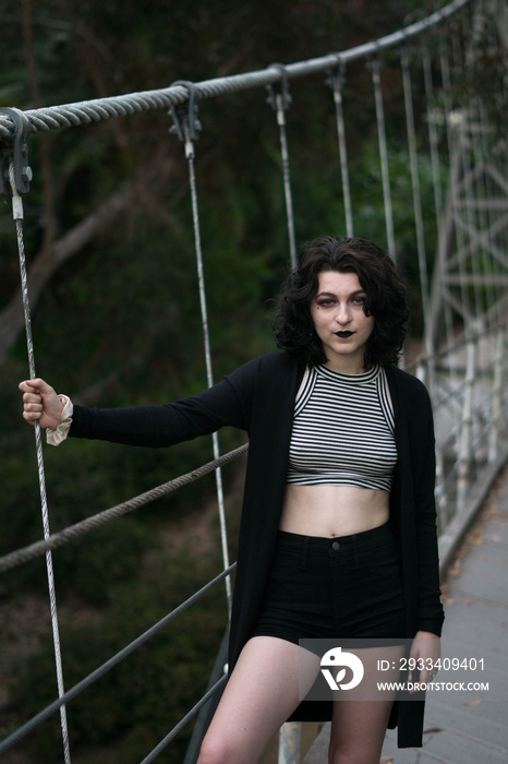 emo goth girl holding on the bridge dramatic