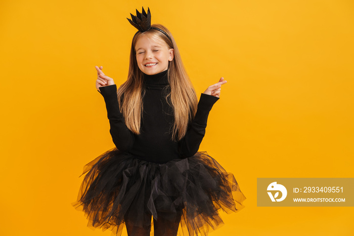 White girl wearing black crown posing with fingers crossed for good luck