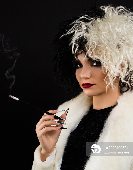 woman dressed up as Cruella halloween character, Black and white  colors . She has cigarette holder 