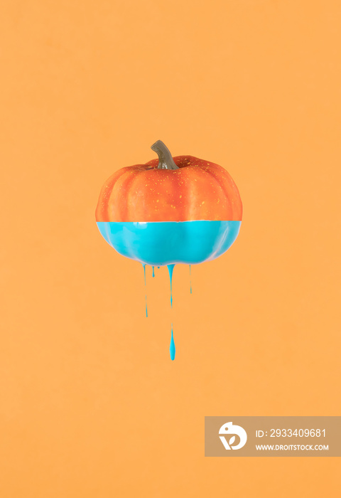 Halloween minimal concept with pumpkin and paint. Creative spooky holiday fun background