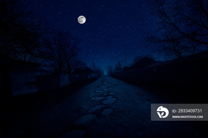 Full moon over the ruins of old grunge building at night. Beautiful night landscape with full moon. 