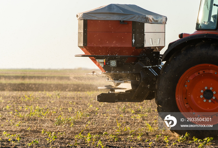 Tractor spreading artificial fertilizers