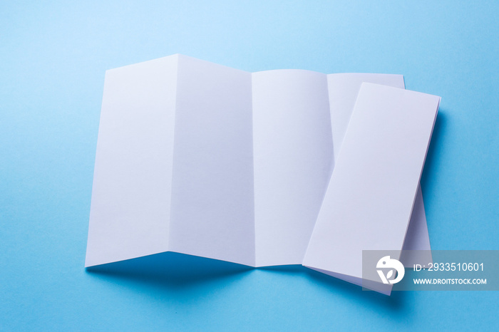 Leaflet blank Four-fold white paper brochure mockup on blue background