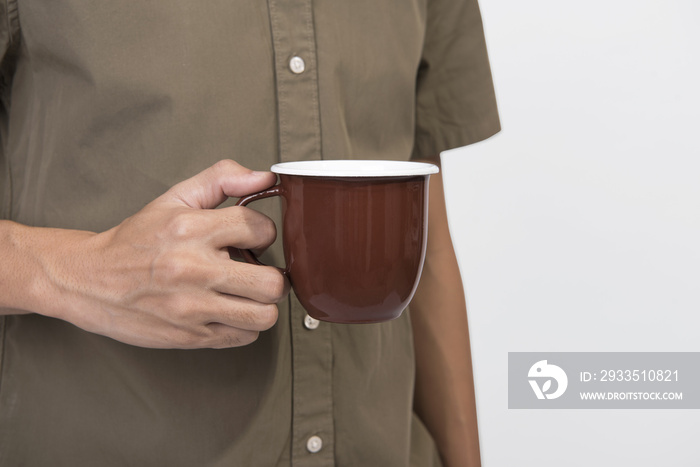 Hand Holding brown coffee cup. mockup for creative design branding.