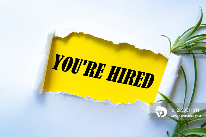 Text sign showing You’re Hired