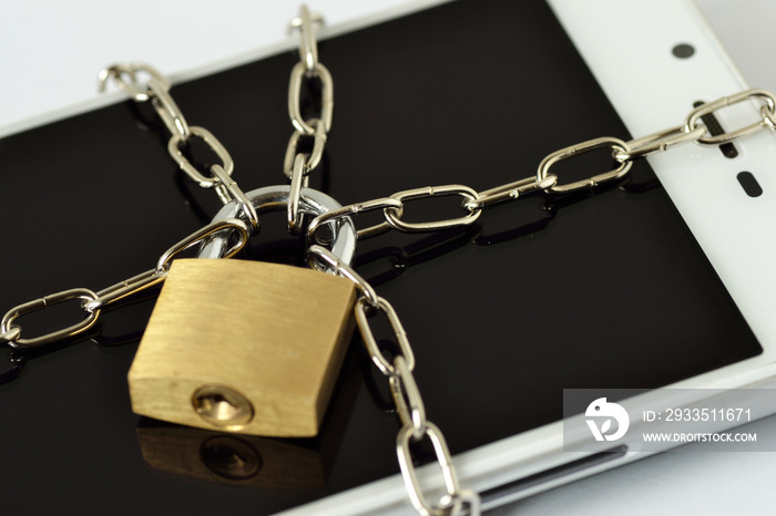 Close-up of smartphone locked with chain and padlock - Concept of mobile security and data privacy