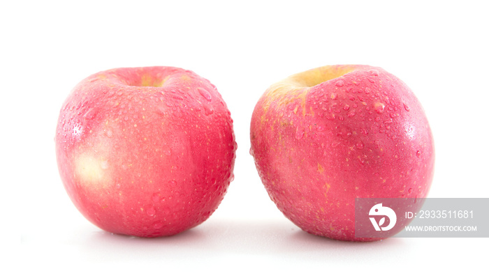 Two red apples with water drops on white background