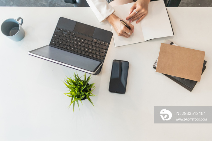 blurred photo,laptop and document placed on the office desk window to save energy as it uses natural light to help work during the day and make business people happy to work and talk business.