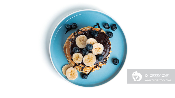 Pancakes with berries and chocolate isolated on a white background.