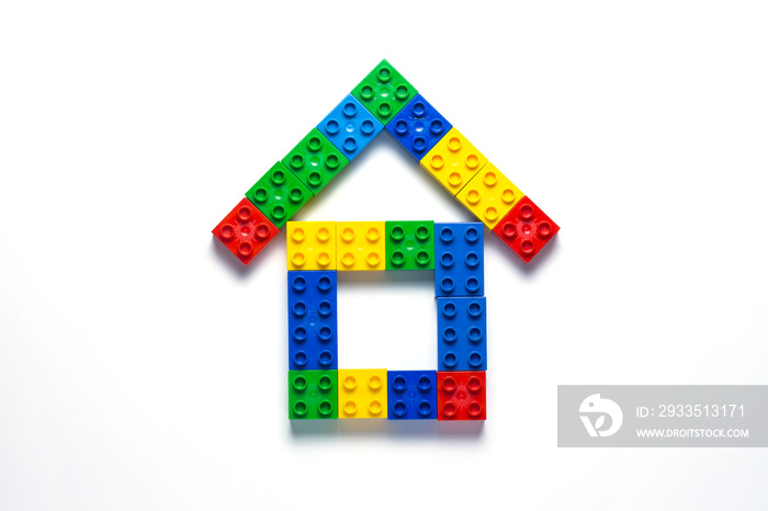 House from the children’s designer on a white background. The concept of building houses, building. Flat lay, top view.