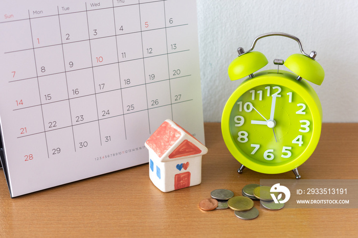 Calendar and house on table. Day of buying or selling a house or payment for rent or loan.