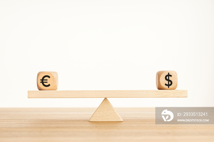 Euro and dollar parity concept. Dollar and euro symbol on wooden blocks on a seesaw. Copy space