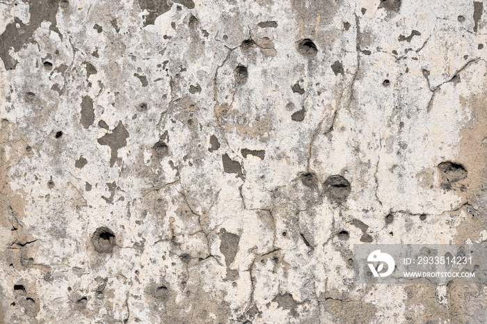 Concrete wall background with bullet holes