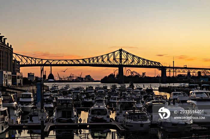 Beautiful Sunrise in Old Port, clock tower and Jacques Cartier Bridge against sunset sky, Montreal, Canada