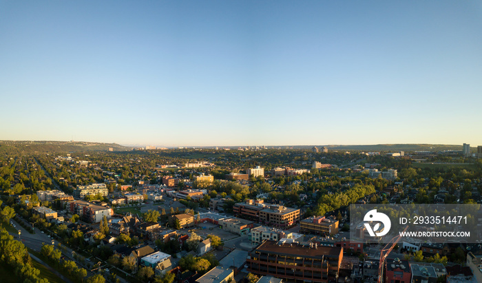 Aerial view of residential area in Calgary City during a vibrant summer sunrise. Located in Alberta, Canada.