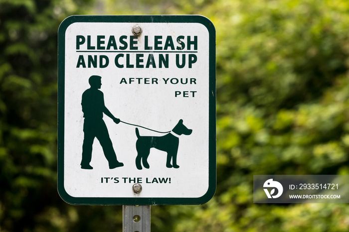 Dog leash and scoop sign with green tree