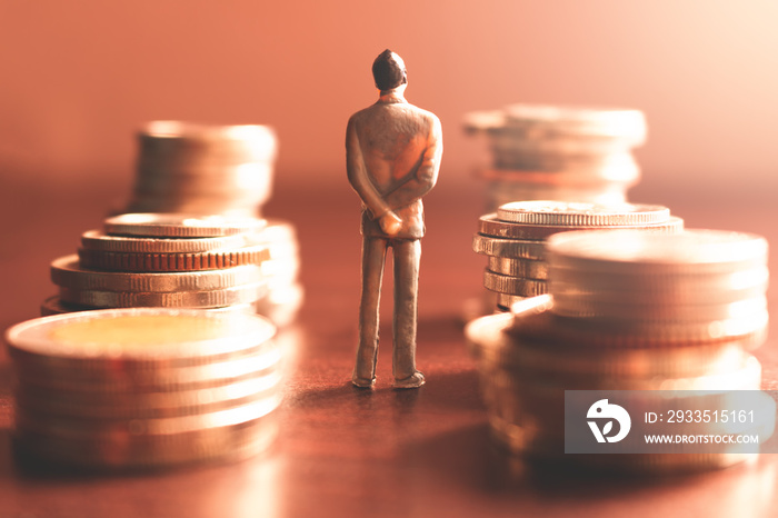 Miniature people standing with stack coin about financial and money savings concept.