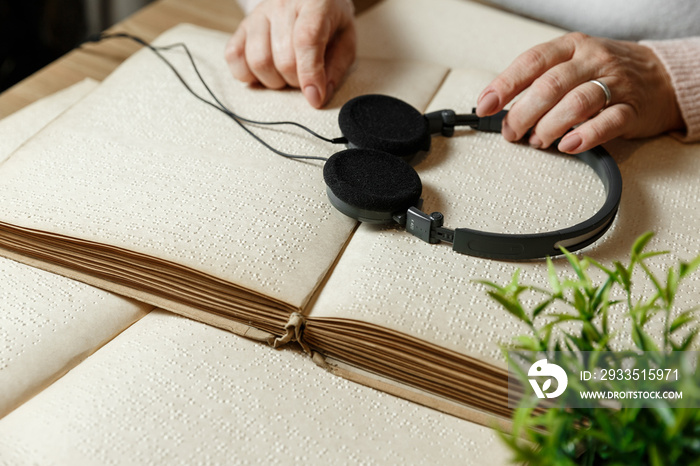 woman reading braille text on old book