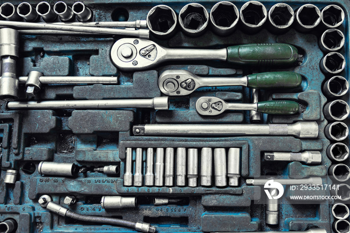 Above view of used greasy old dirty car repair mechanic hand tool set kit vehicle repair and maintencae service. Hardware toolkit with many different garage equipment. Automobile fix background