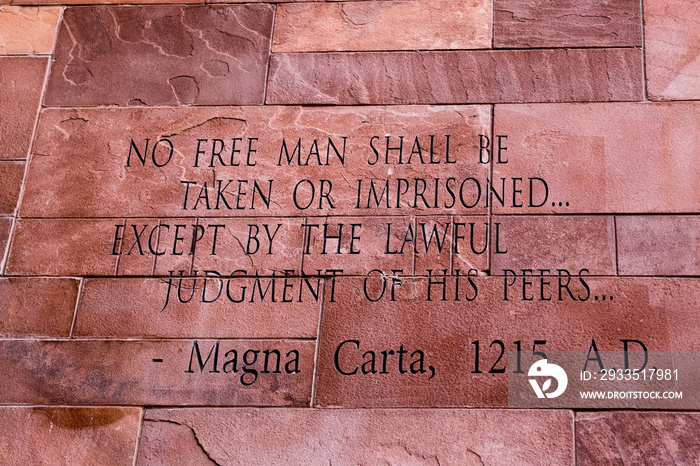 Article of Magna Carta text on of the old brick wall