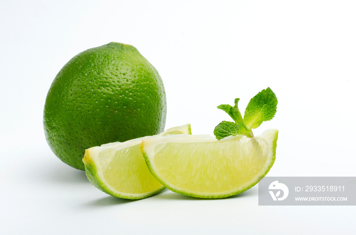 Closeup of lime wedges, mint leaves, whole lime on the white background