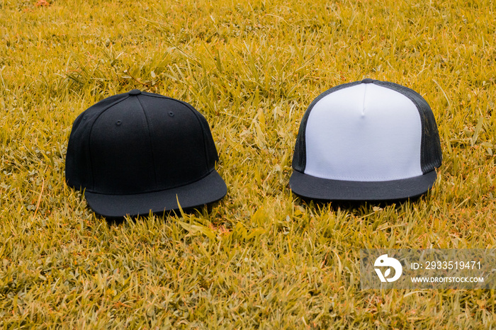 Blank trucker hat and snapback hat cap flat visor with black and white color in outdoor, ready for your mock up design or presentation your design project