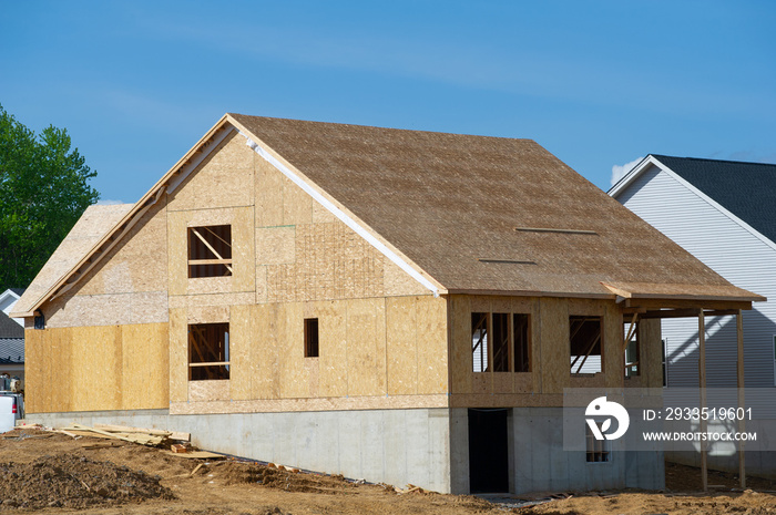 A residential house construction project showing the plywood roof and oriented strand board wall sheathing