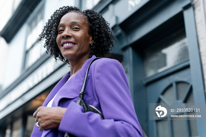 Portrait of smiling woman in purple jacket