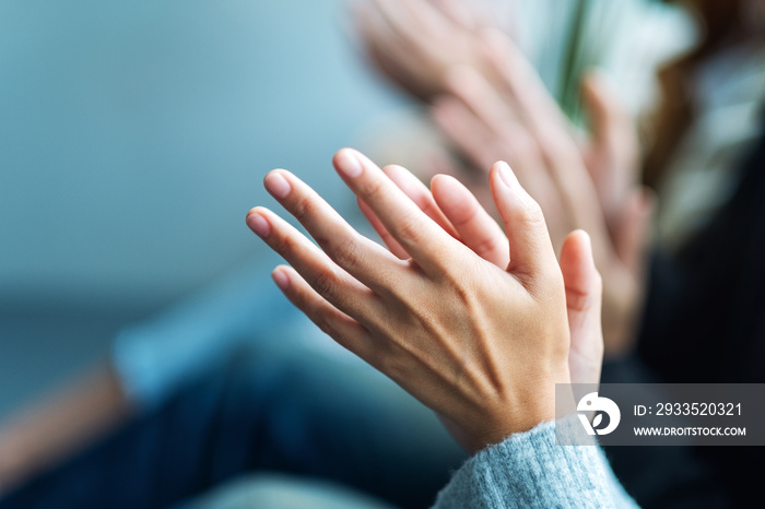 Closeup image of people clapping hands together