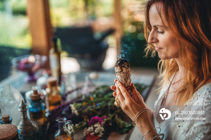 incense in a woman hand, ceremony space.