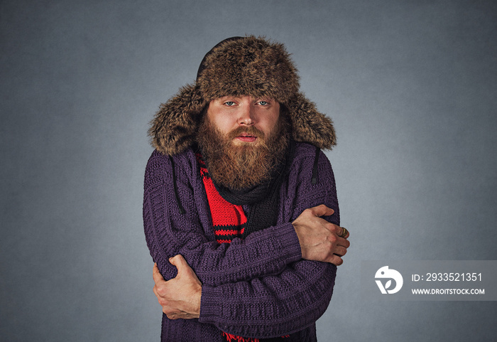 man embracing himself trying to warm up