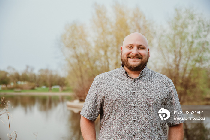 closeup of plus size bald man looking at camera smiling